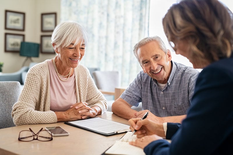 senior couple discussing finances with advisor